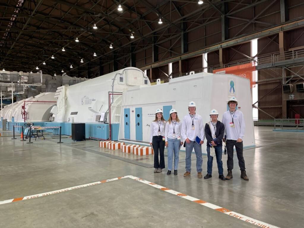 Students on the deck of a large power plant