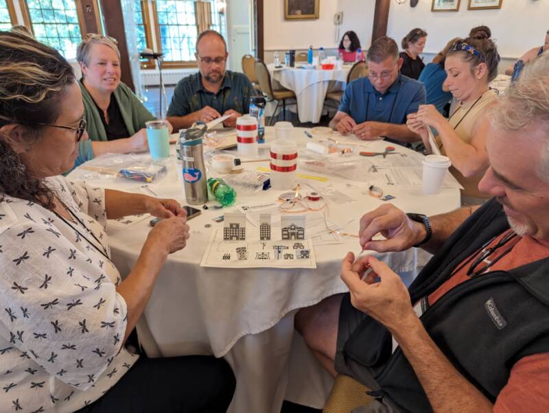 Science teachers working on experiments at a table