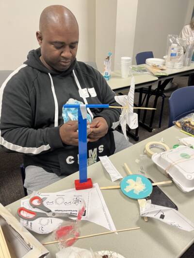 Teacher building a mini wind turbine