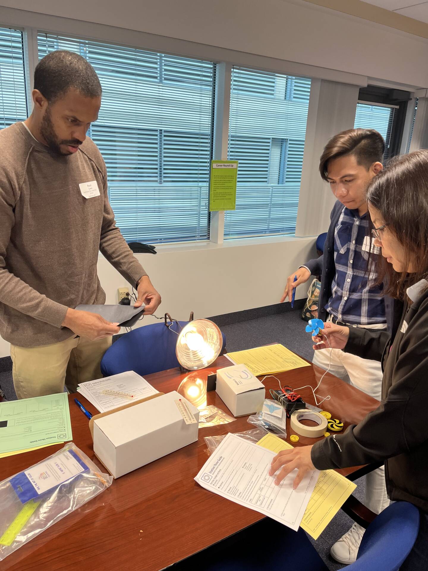 Teachers gathered around a light bulb experiment