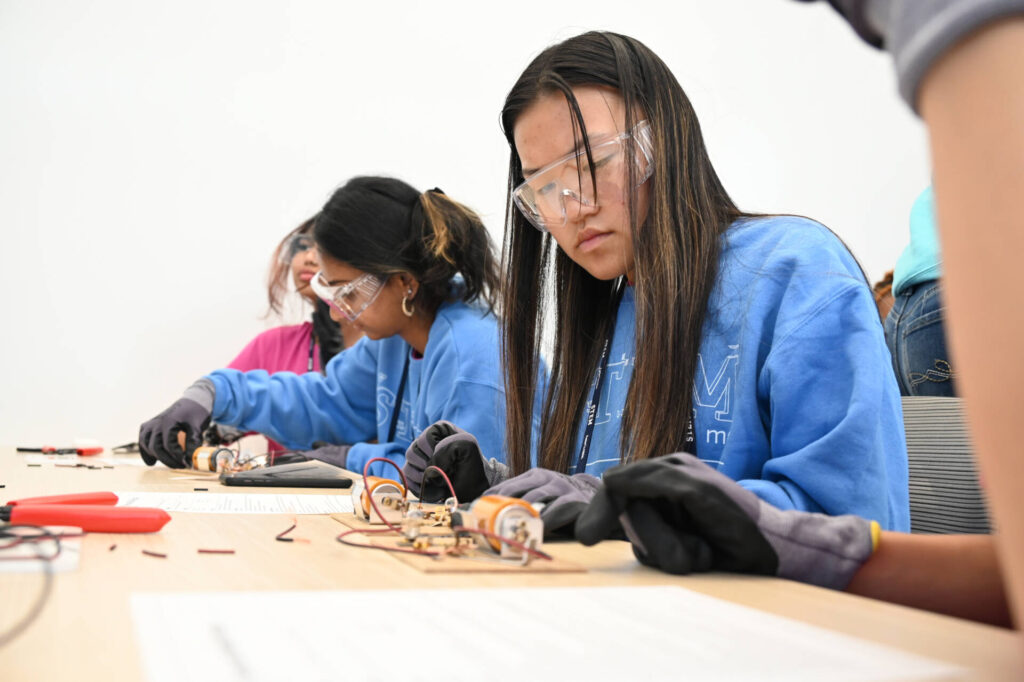 Students soldering science experiments