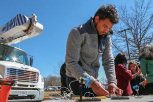 Man working on setting up a small solar panel for a kids science experiment