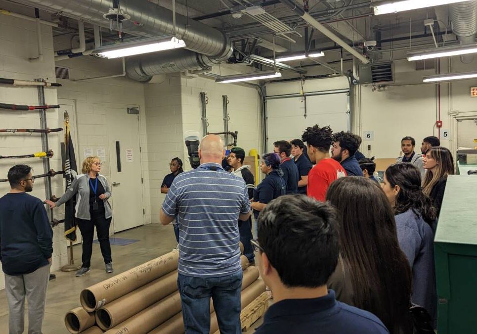 Students and teachers learning in a factory