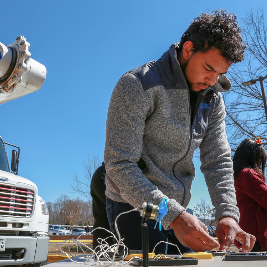 Man working on setting up a small solar panel for a kids science experiment