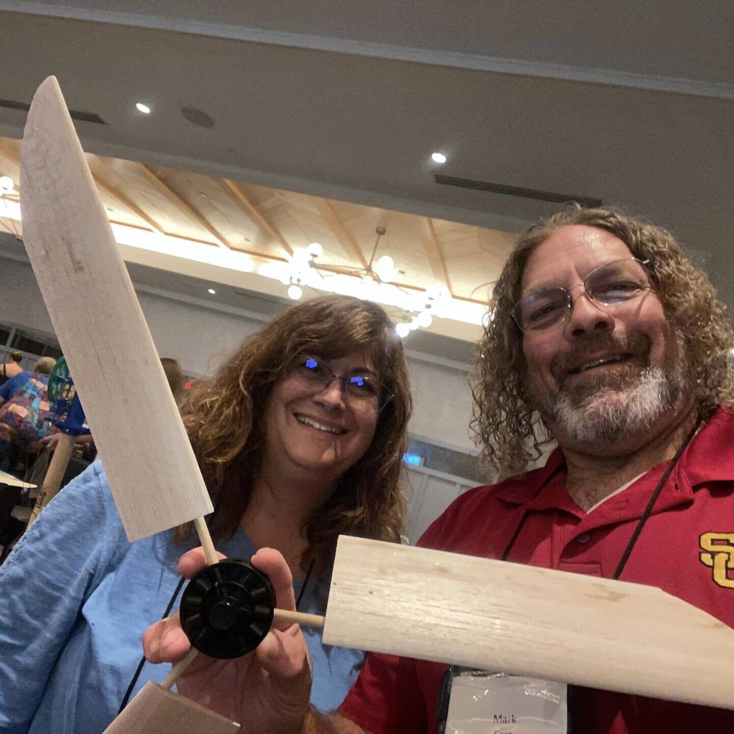 Two teachers holding small wind turbine blades