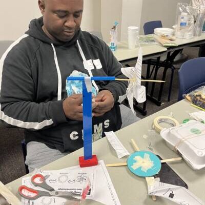 Teacher building a mini wind turbine