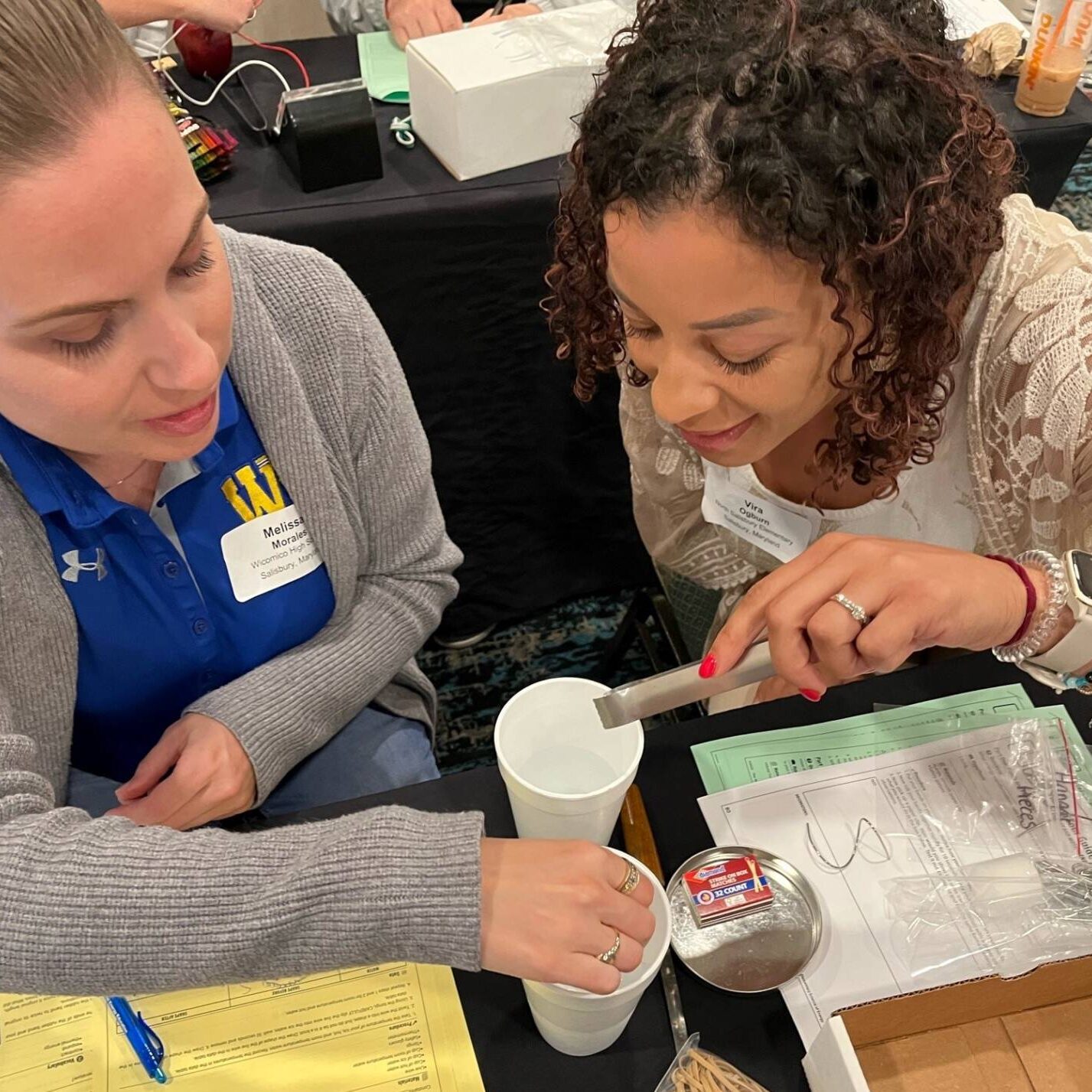 Two teaches performing a science experiment