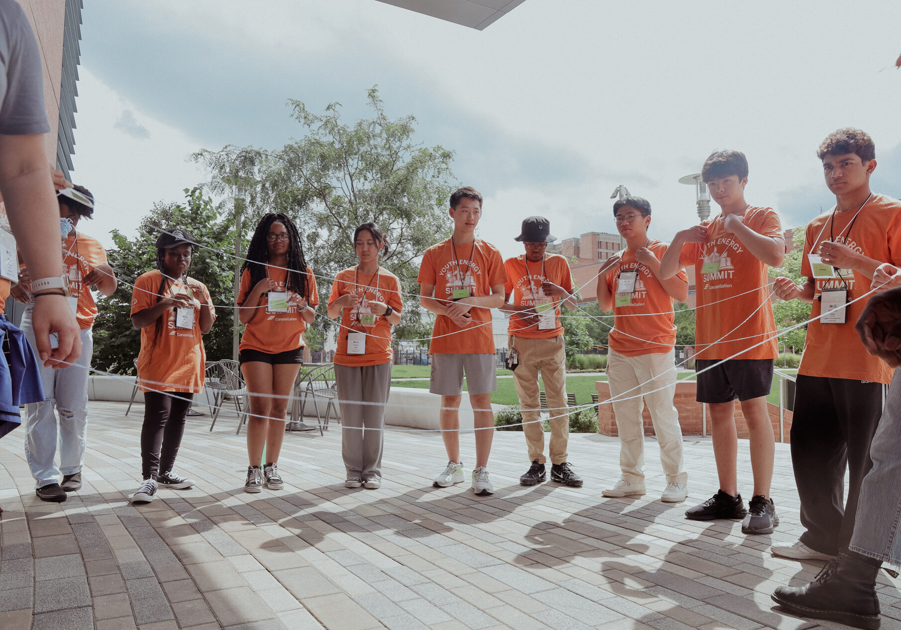 Students in matching t-shirts working with string in a group