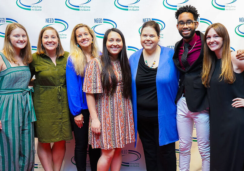 Smiling group of students with NEED's executive Director